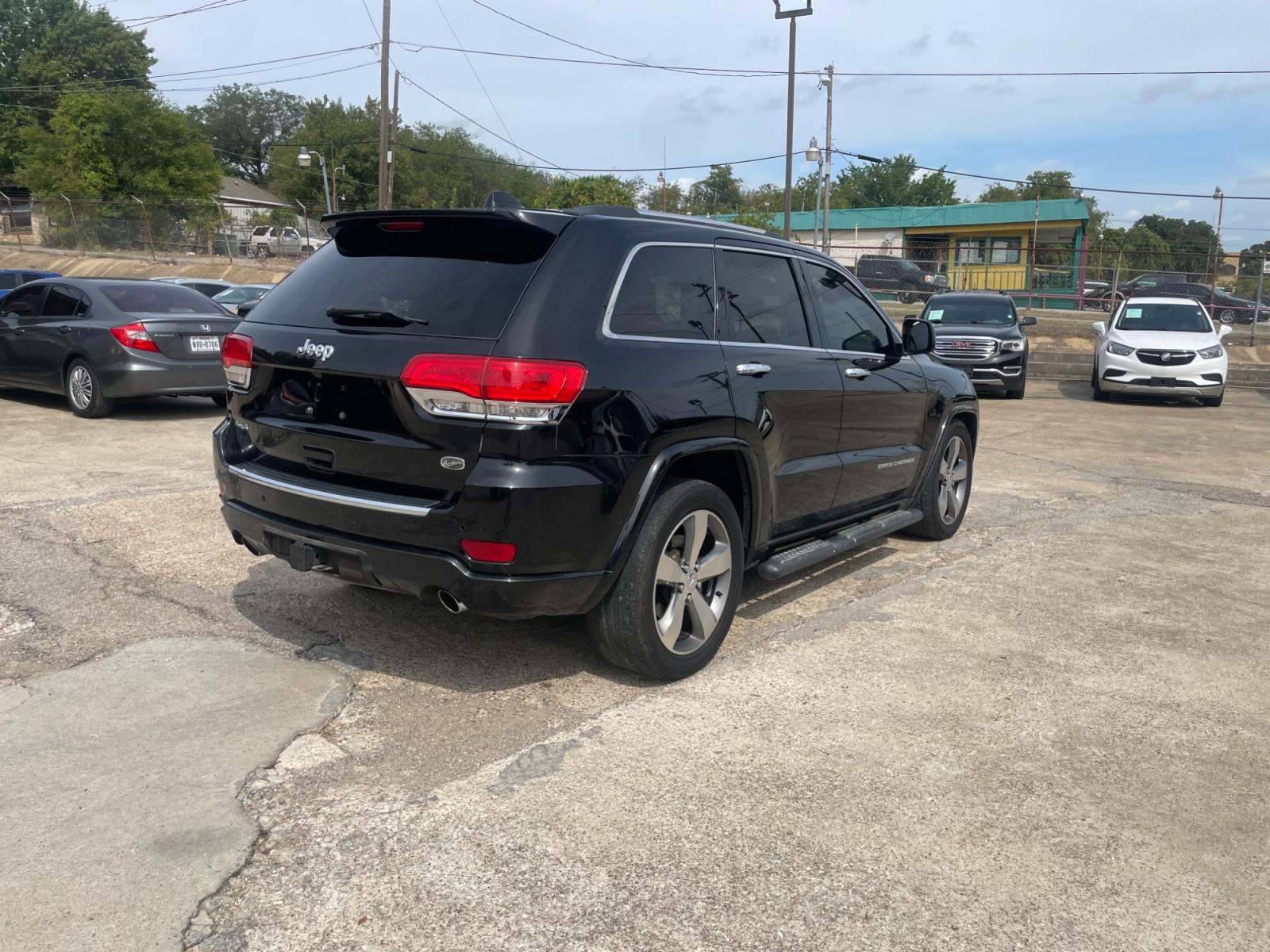 2014 Jeep Grand Cherokee Overland 4WD (1C4RJFCT9EC) with an 5.7L V8 OHV 16V engine, 5-Speed Automatic transmission, located at 945 E. Jefferson Blvd, Dallas, TX, 75203, (214) 943-7777, 32.752514, -96.811630 - Photo #2